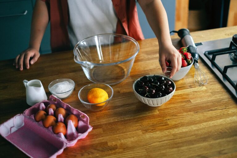 İşte o fotoğraf için hem SEO dostu hem de son derece doğal duran Alt Text önerisi:

Ahşap mutfak tezgahı üzerinde tatlı yapımı için hazırlanmış taze yumurta, vişne ve toz şeker.

### Neden bu şekilde yazdım?
   Betimleyici: Görseldeki ana öğeleri (yumurta, vişne, şeker) net bir şekilde belirtir.
   Bağlam Kurucu: Tatlı yapımı için ifadesiyle fotoğrafın amacını açıklar.
   SEO Uyumlu: Anahtar kelimeleri (mutfak tezgahı, taze yumurta, şeker) organik bir akışla içerir.
   İnsansı: Close-up veya Ingredients gibi teknik terimler yerine, bir insanın o sahneyi gördüğünde söyleyeceği şekilde kurgulanmıştır.